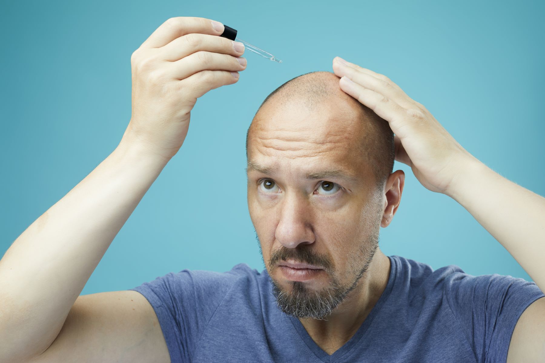 Man using jojoba oil for hair loss