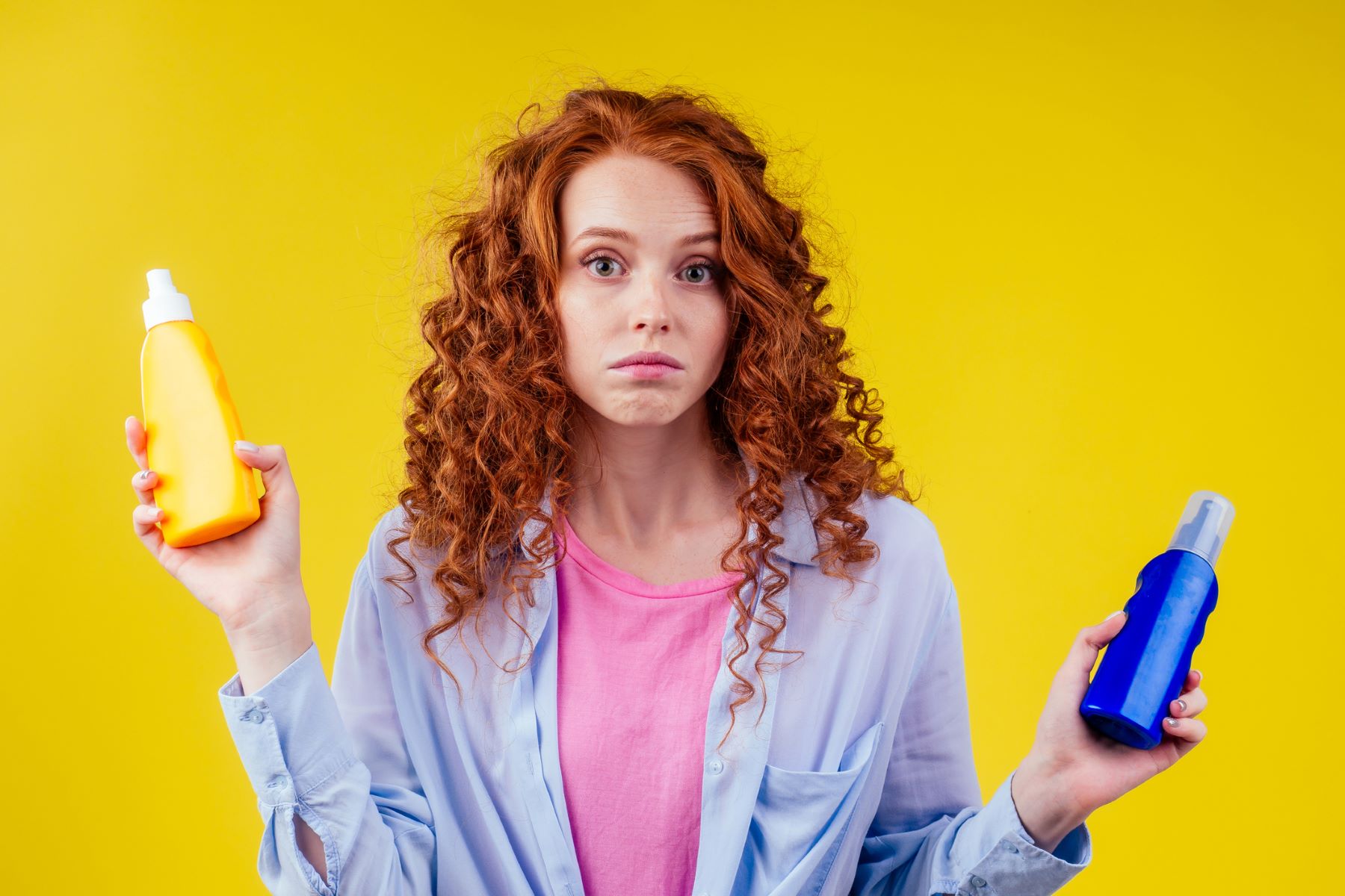 Woman choosing between UV hair protection products