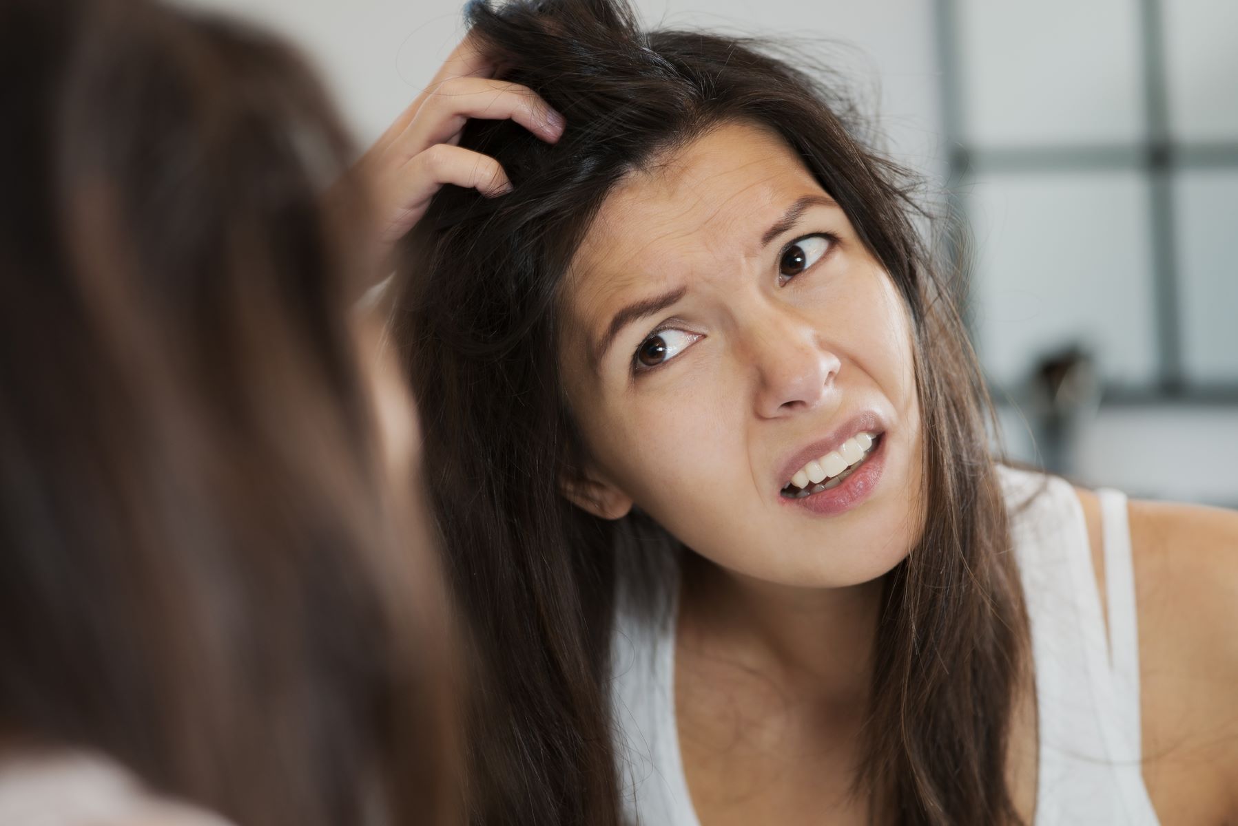 Woman experiencing scalp discomfort