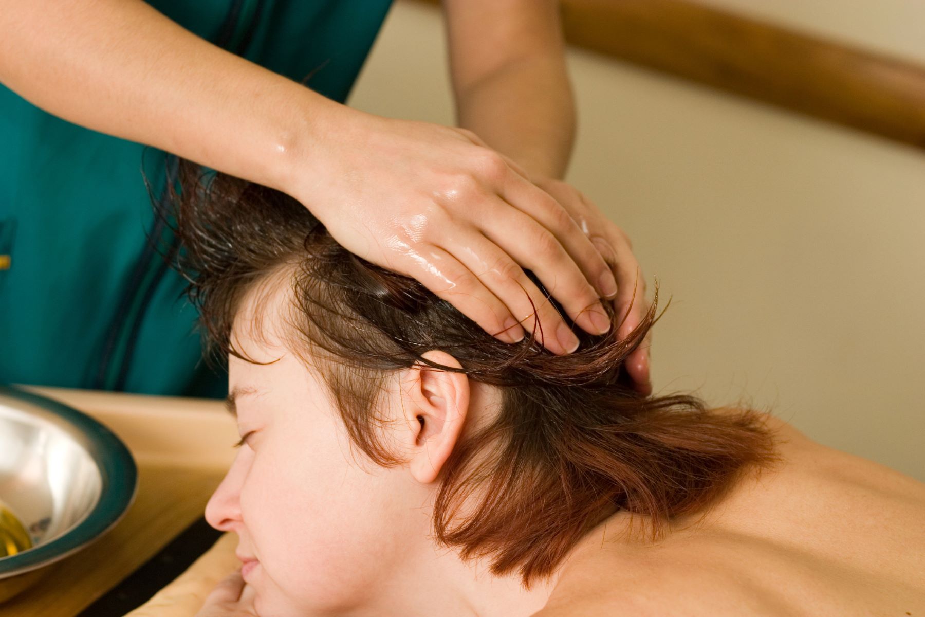 Woman getting a jojoba oil scalp treatment