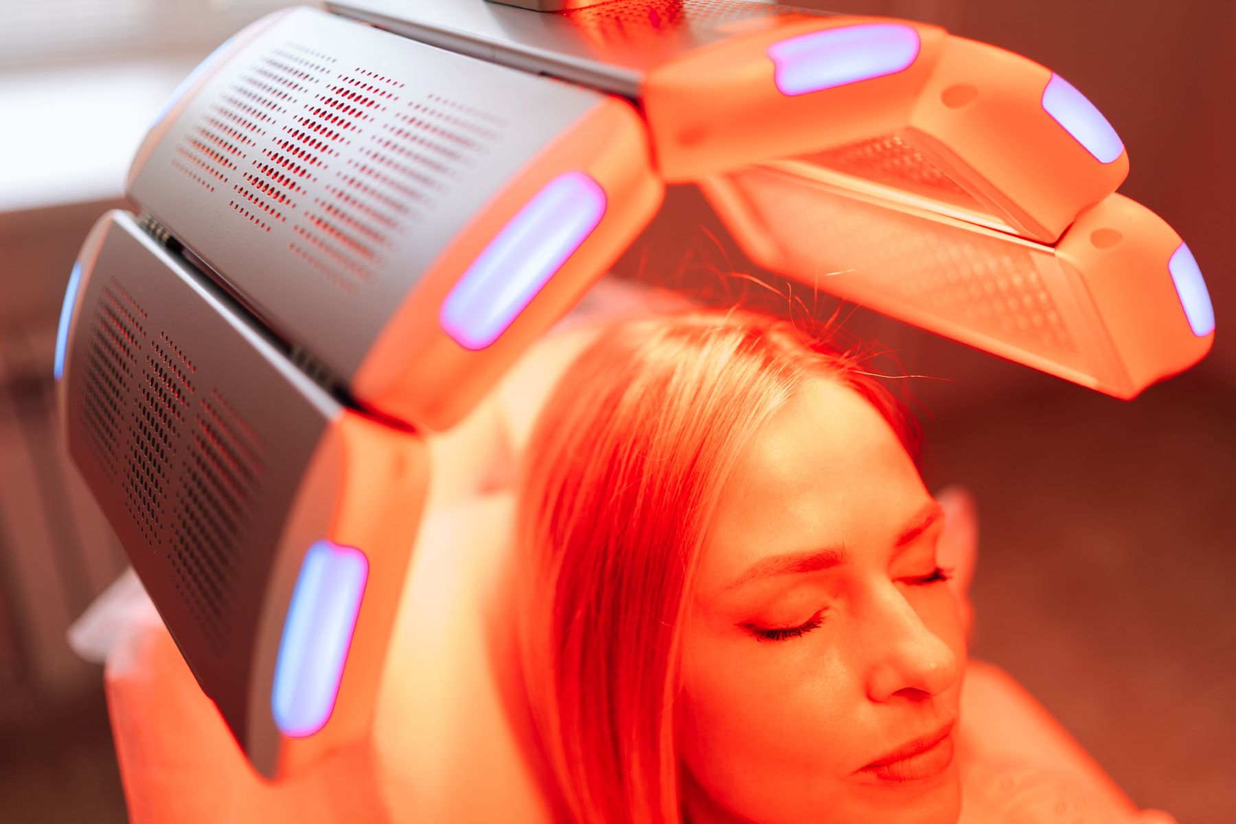 Woman getting red light therapy for hair