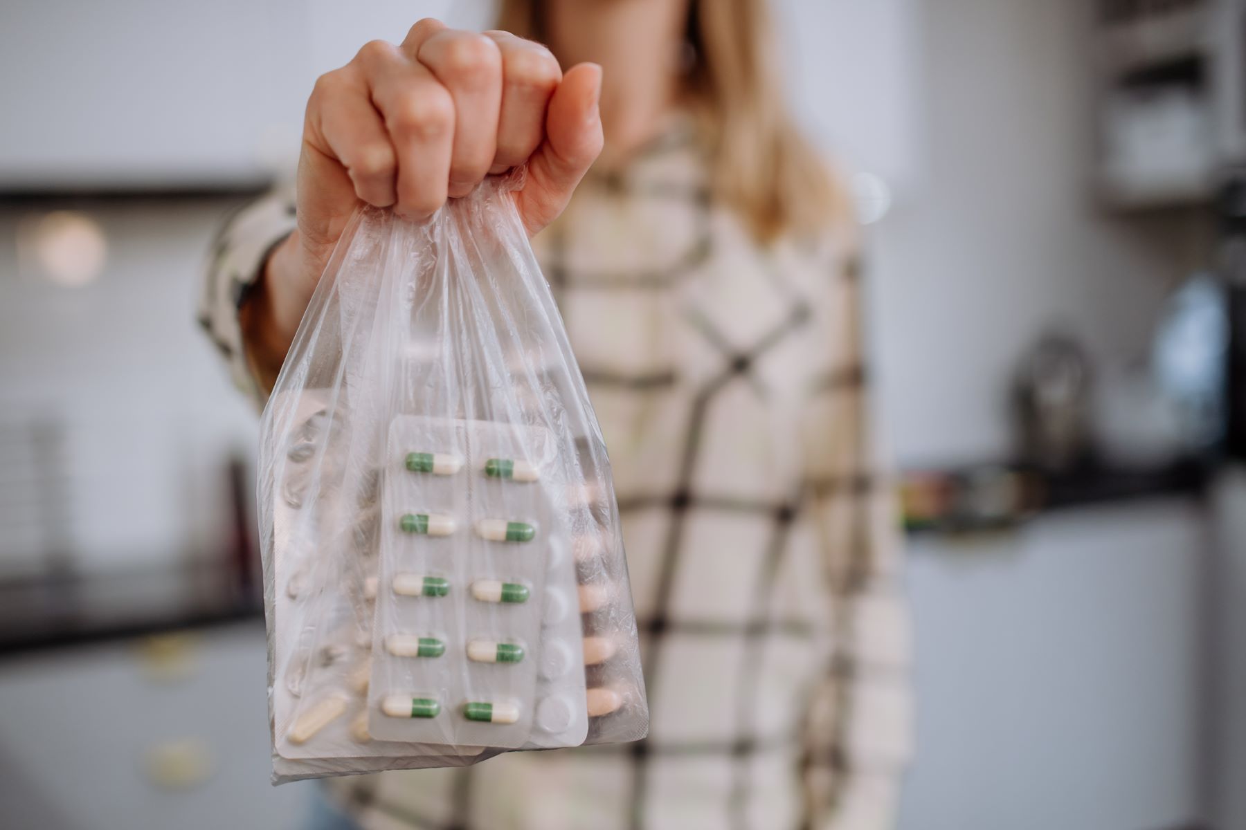 Woman safely disposing of expired medications