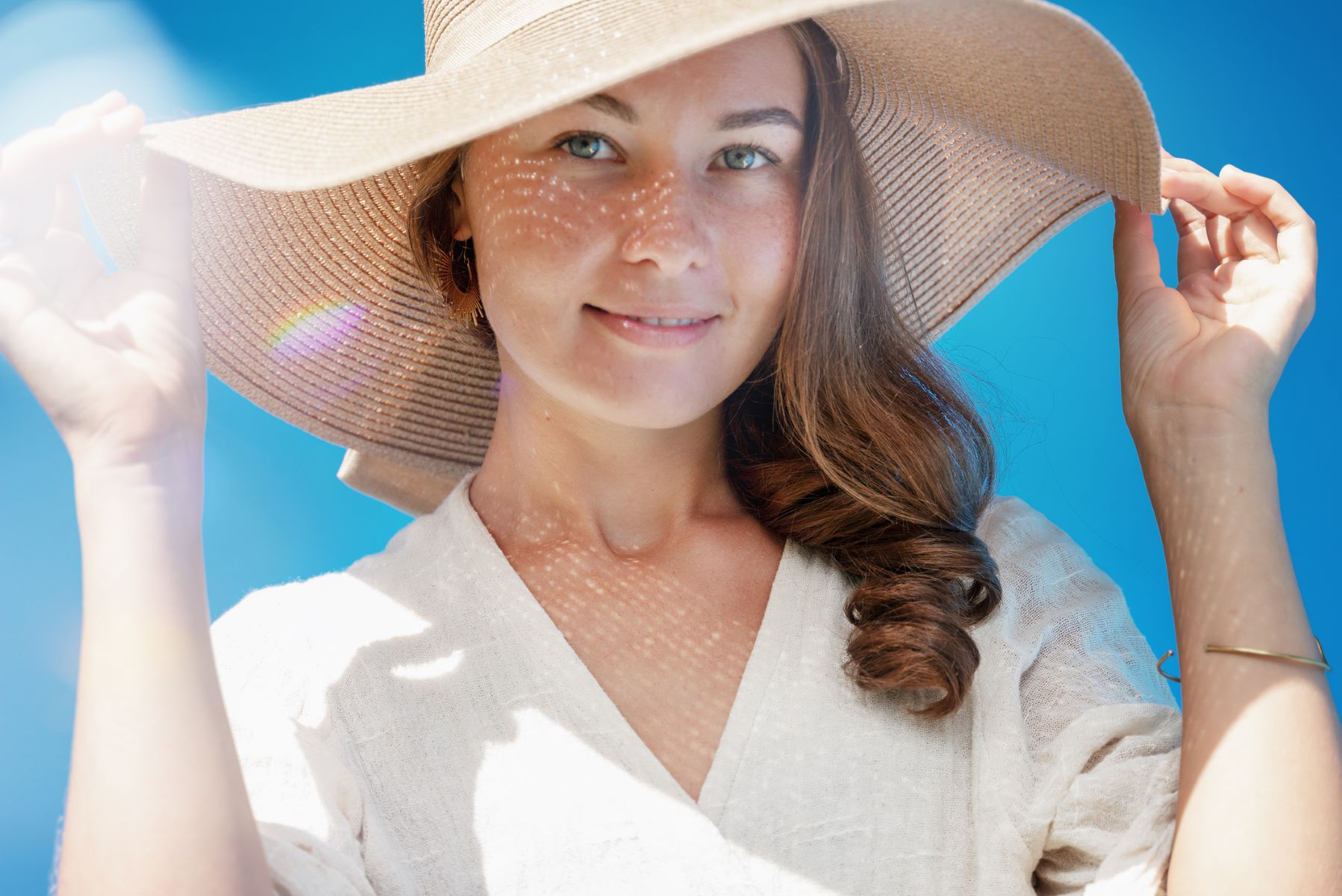 Woman wearing a hat to protect her hair from the sun