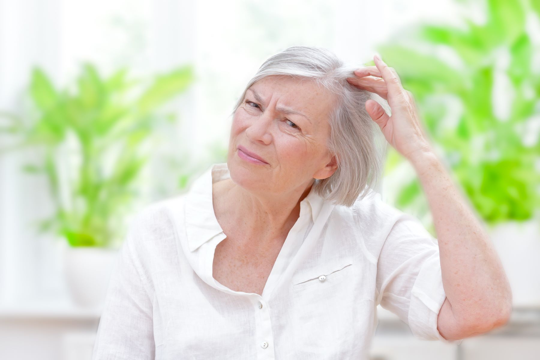 Woman worrying about hair loss from follicular eczema