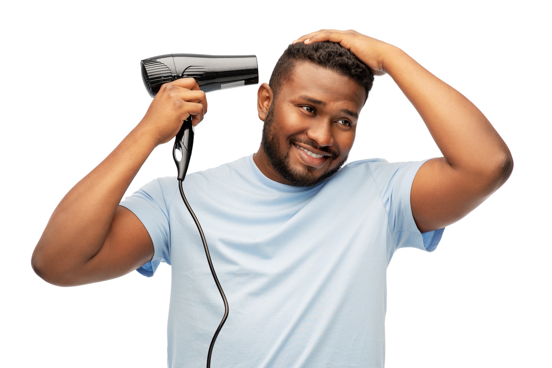 man blowdrying hair to add volume