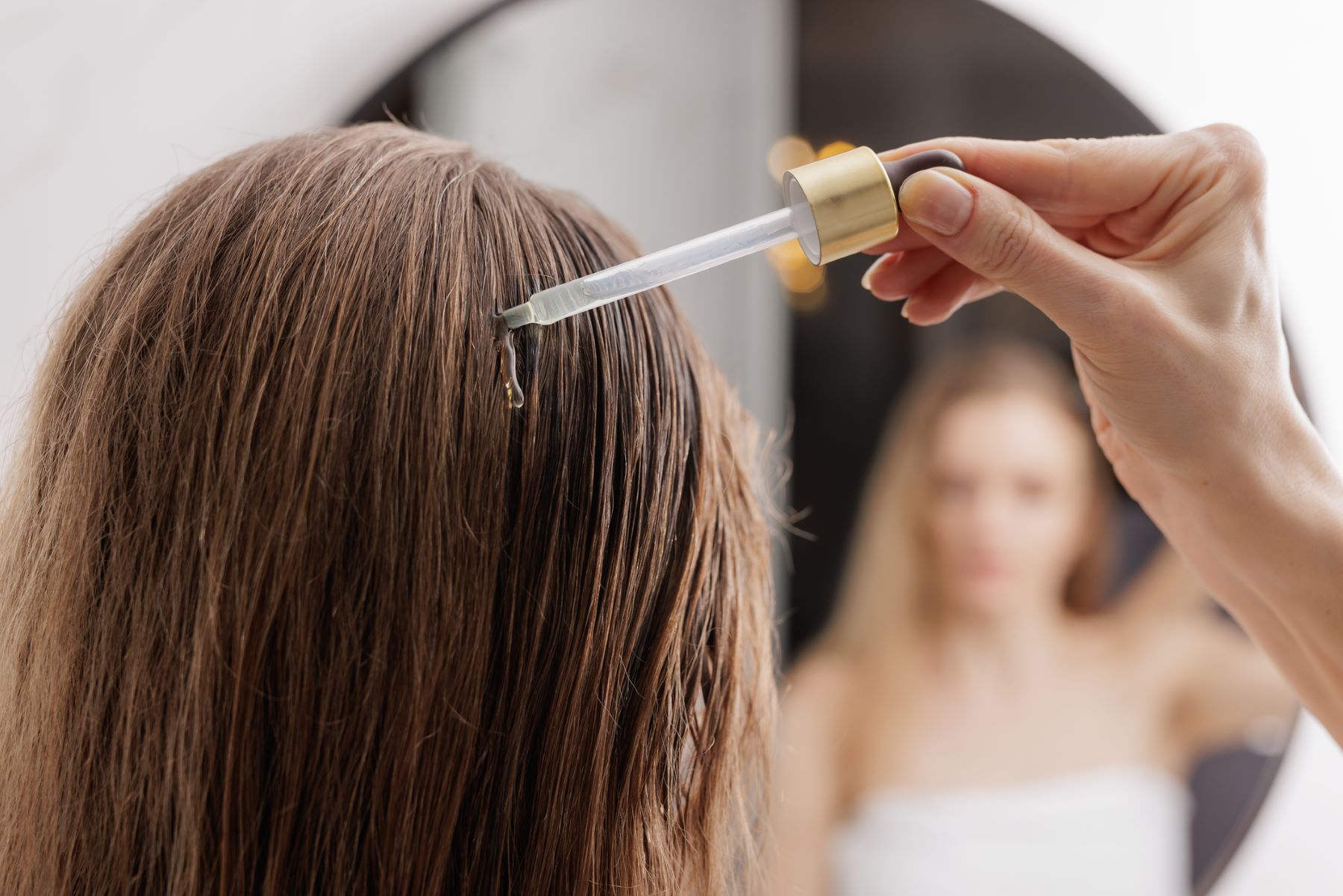 woman using hair oils for moisture