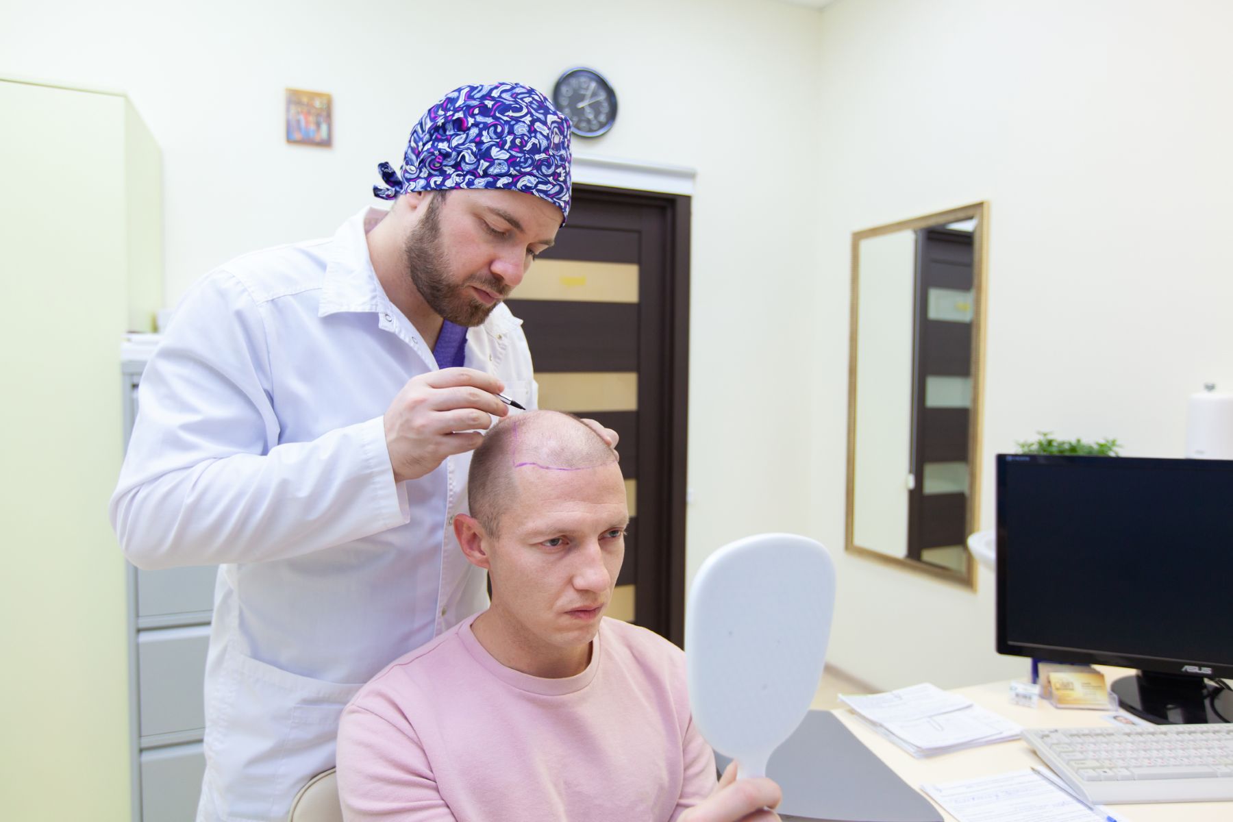 Surgeon performing a hair transplant consultation