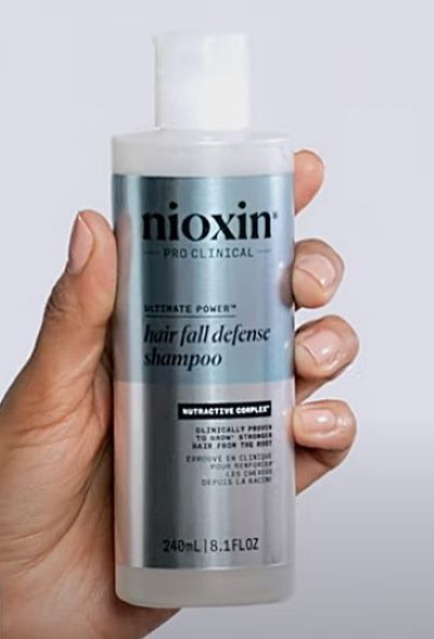 Woman holding Nioxin product