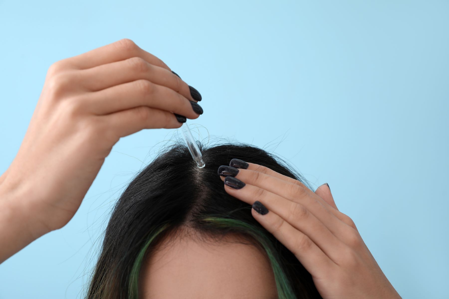 Woman using hair growth treatment