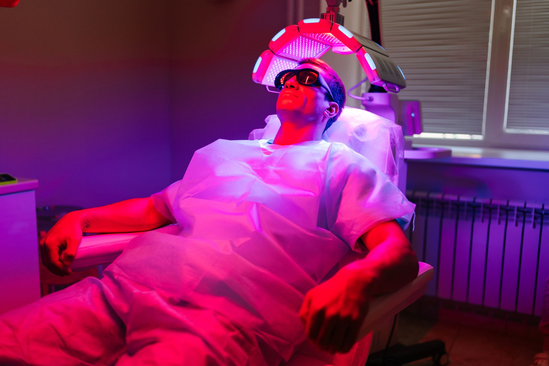 Man getting red light therapy for hair