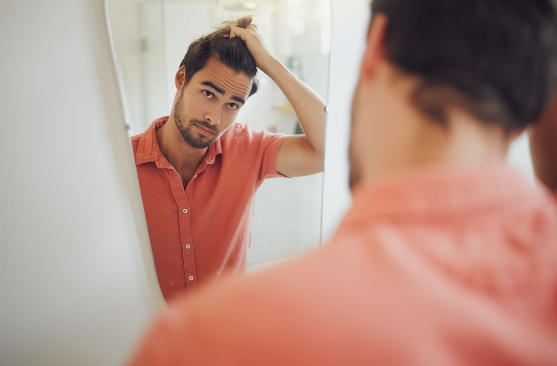 man checking hair density