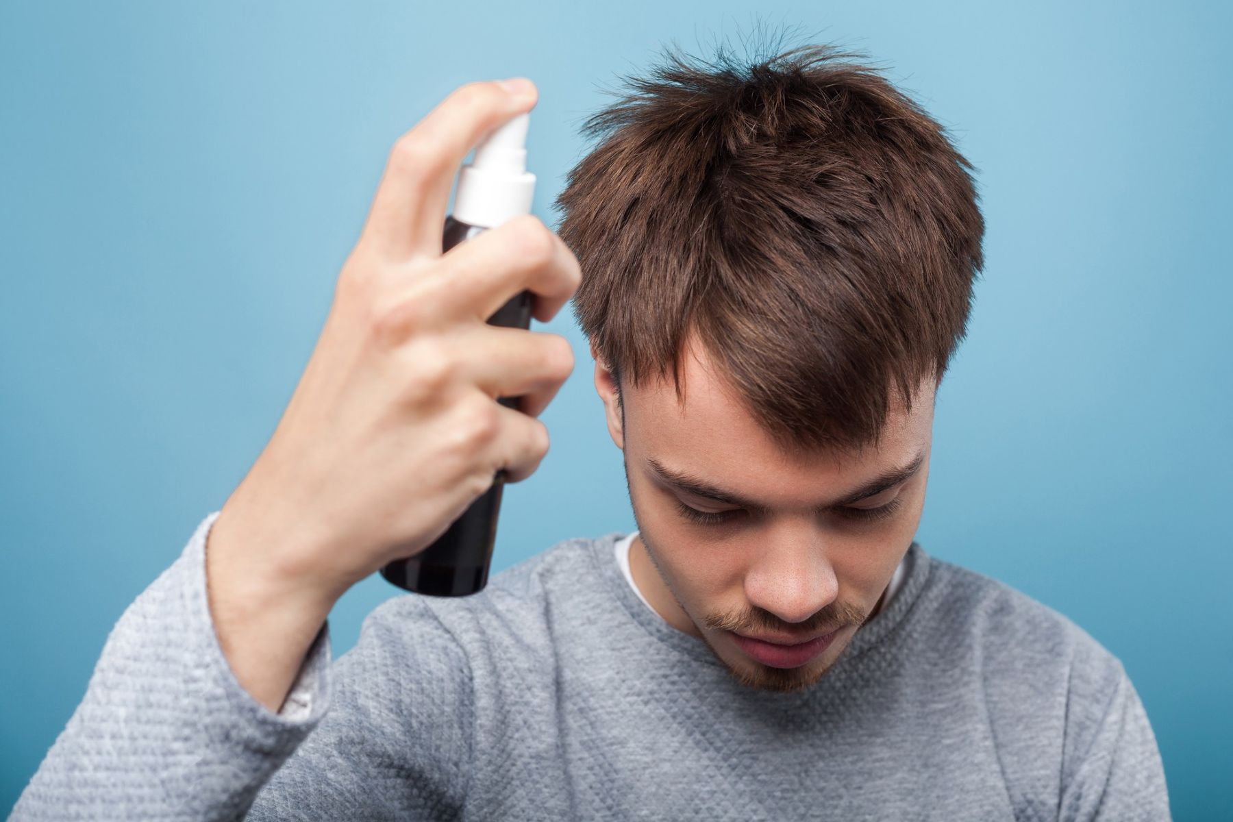 Man applying leave-in conditioner