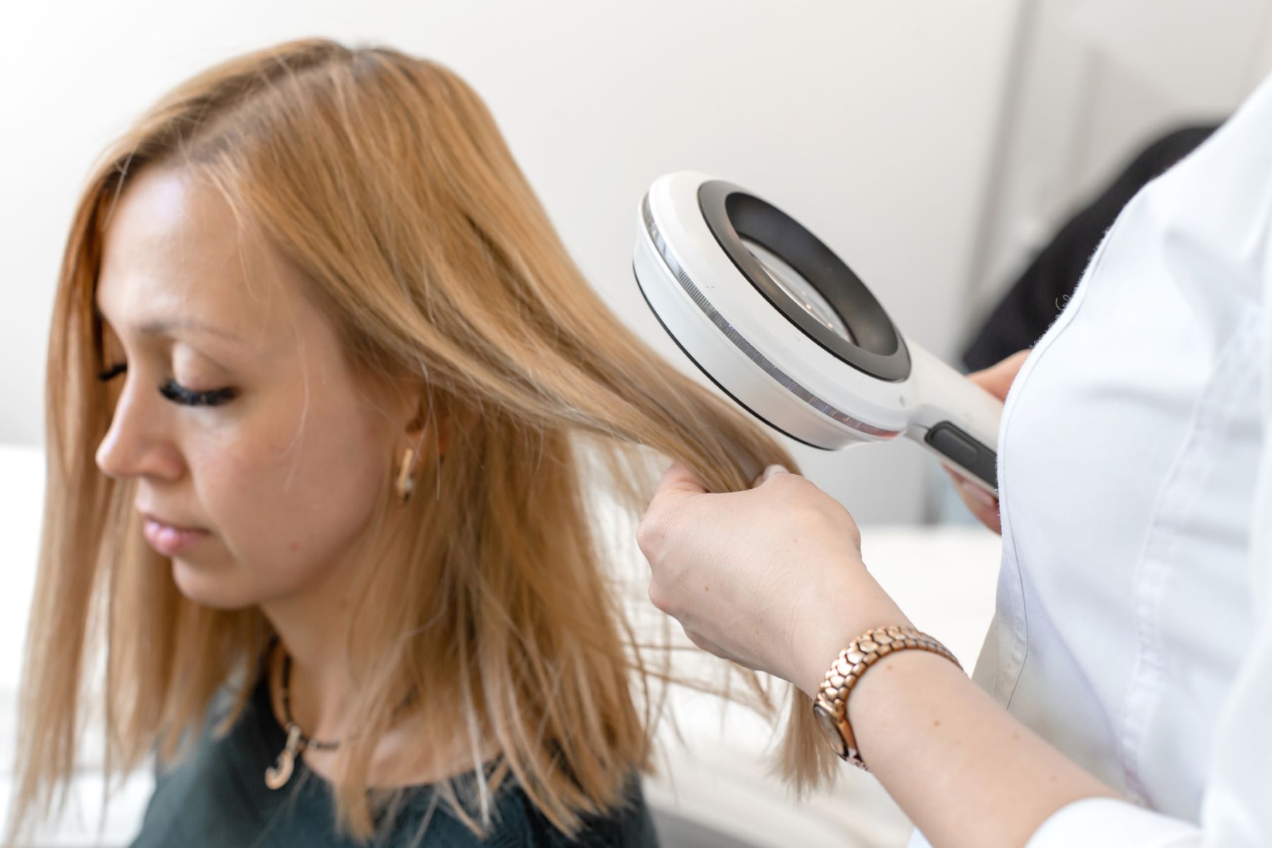 Trichologist assessing hair damage