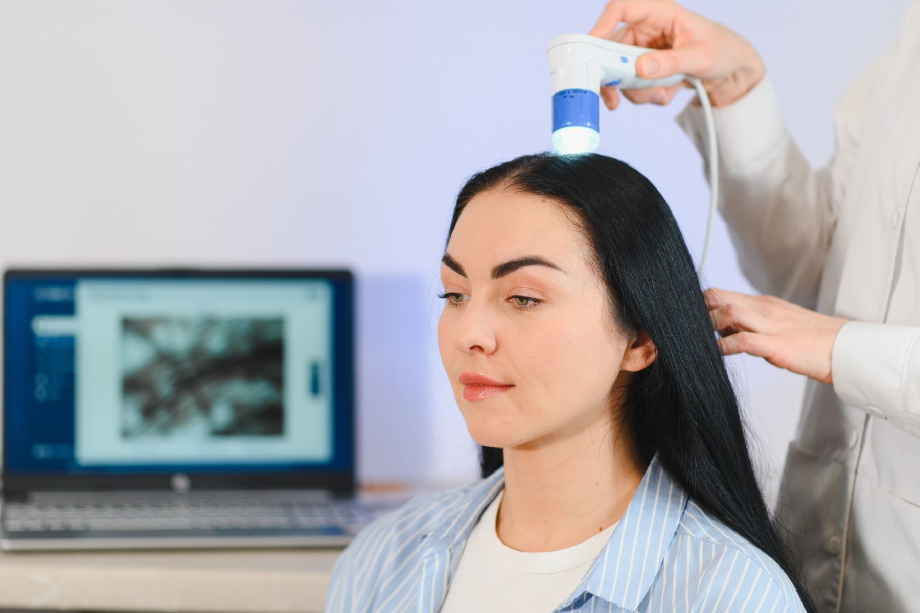 Trichologist diagnosing woman’s hair loss