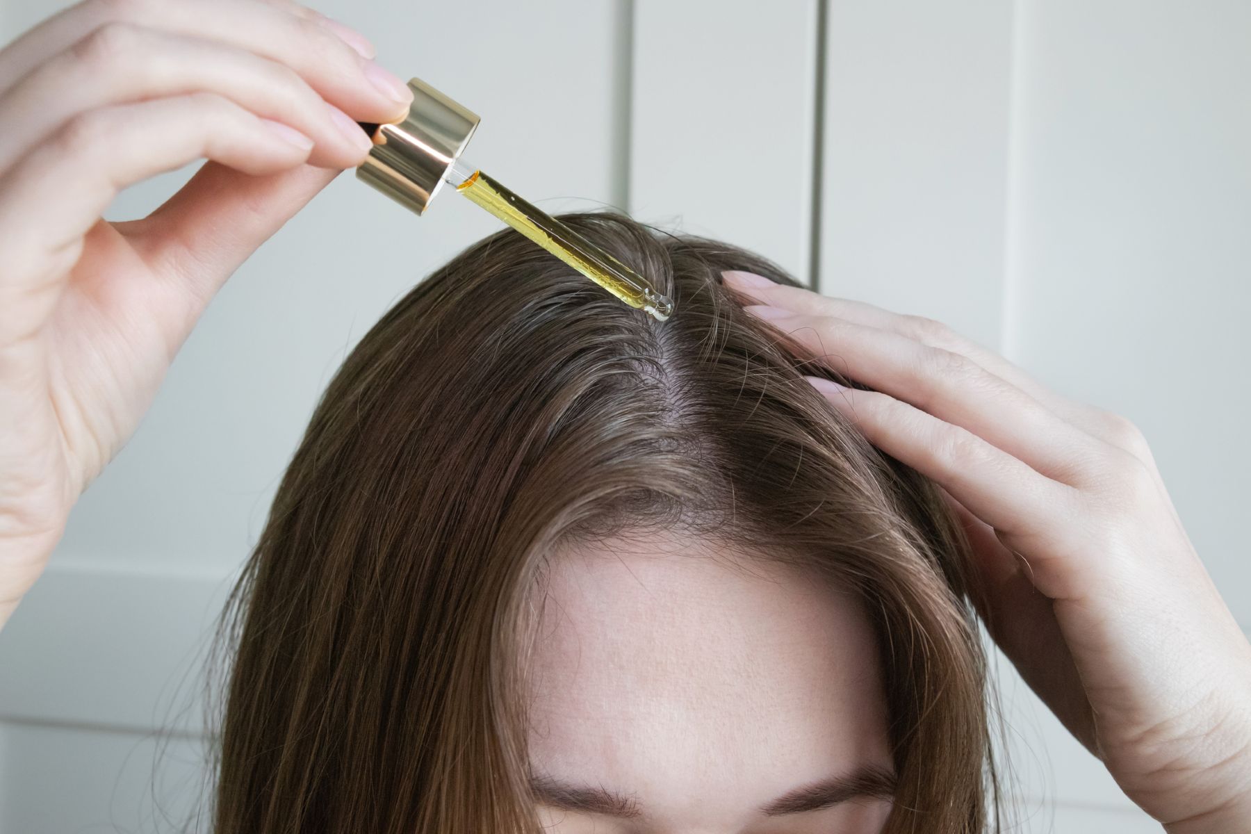 Woman using hair growth treatment