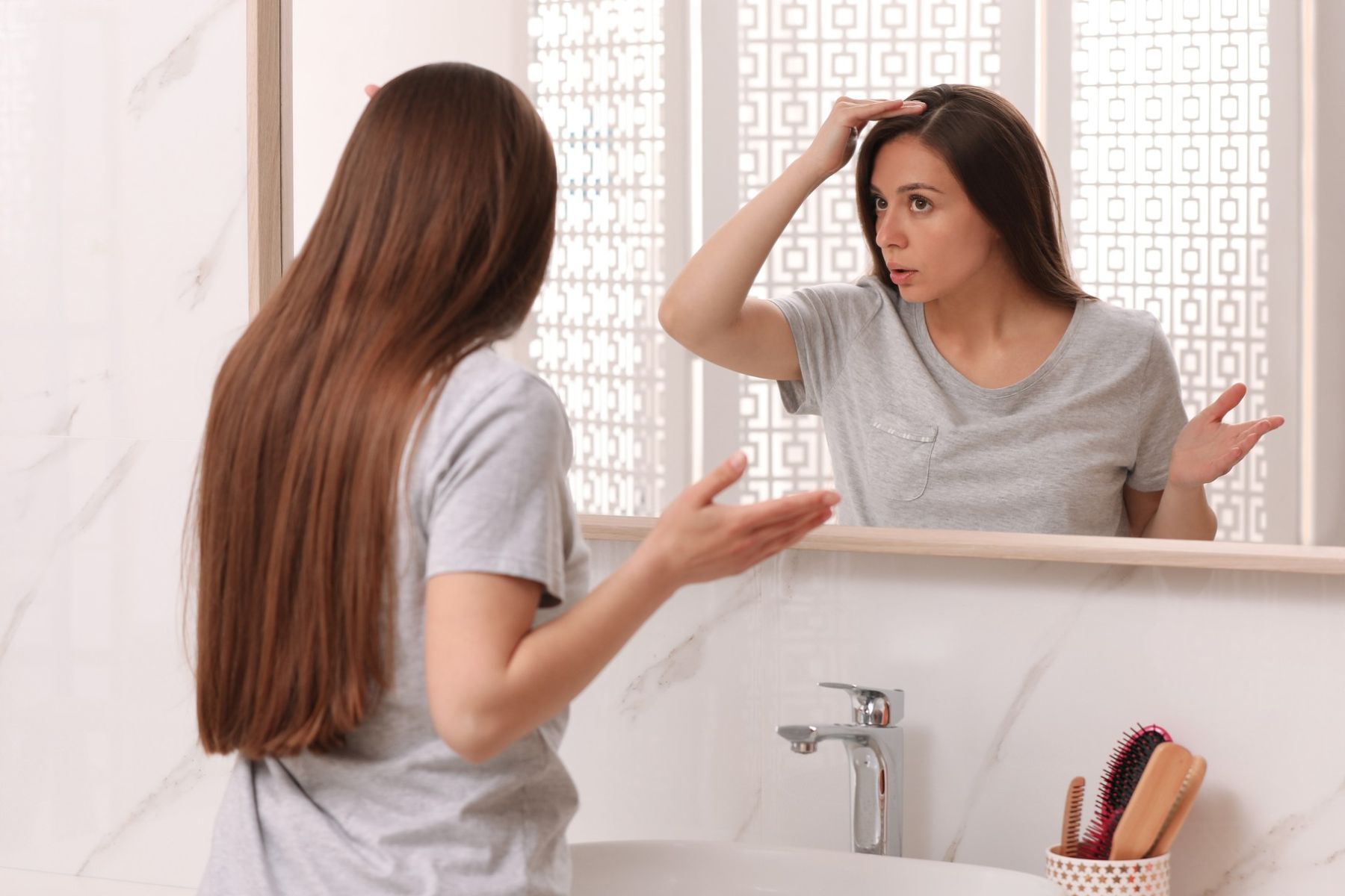 Woman wondering what is causing her hair loss