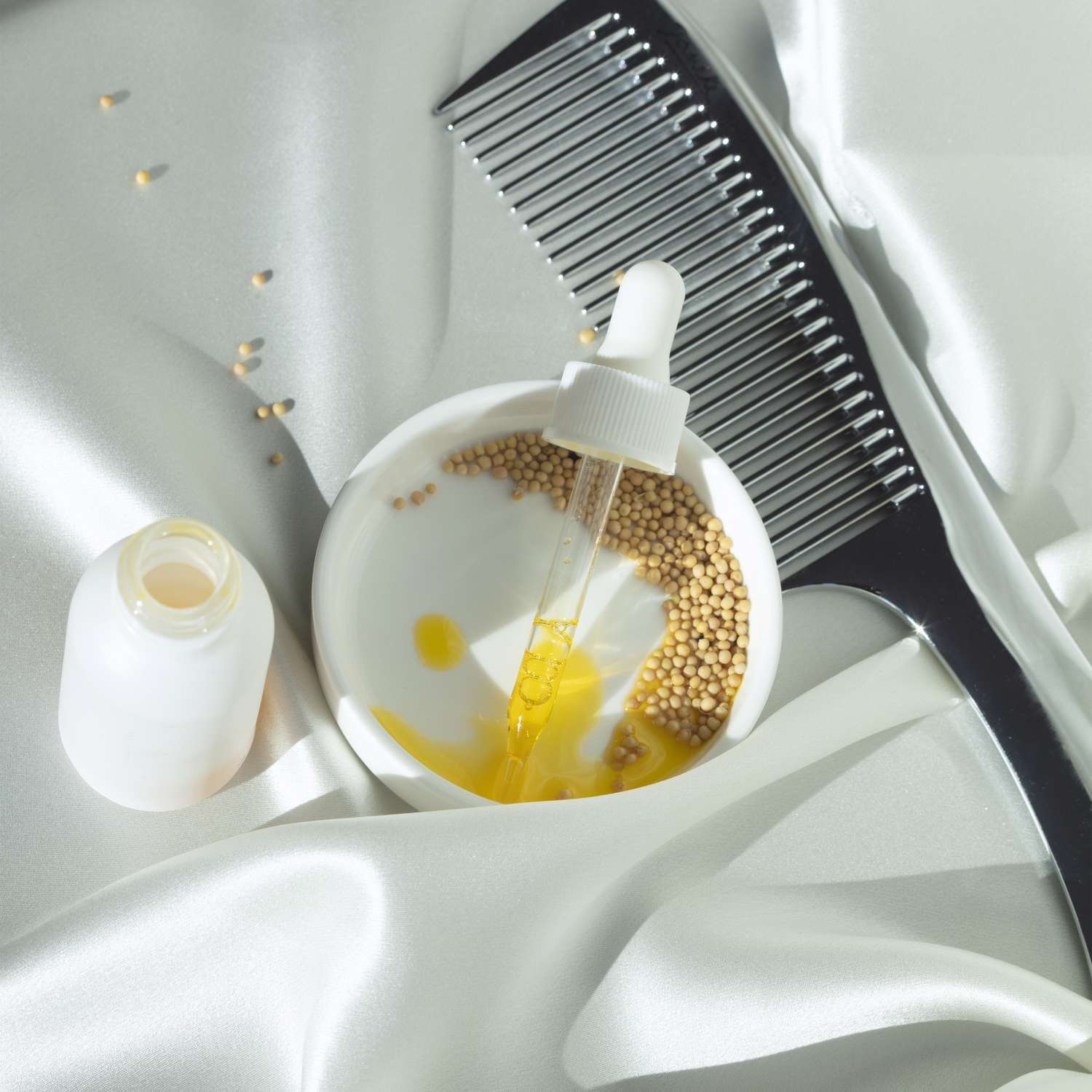 A comb, mustard seeds, and oil