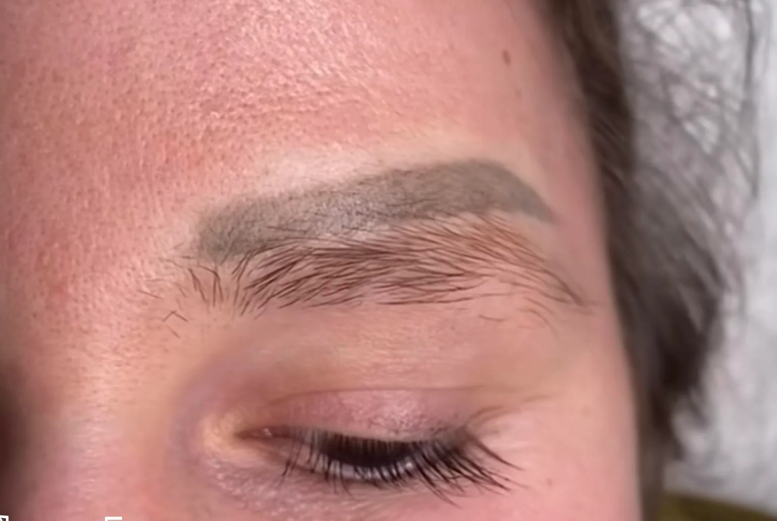 Eyebrow tattooed in the wrong place.