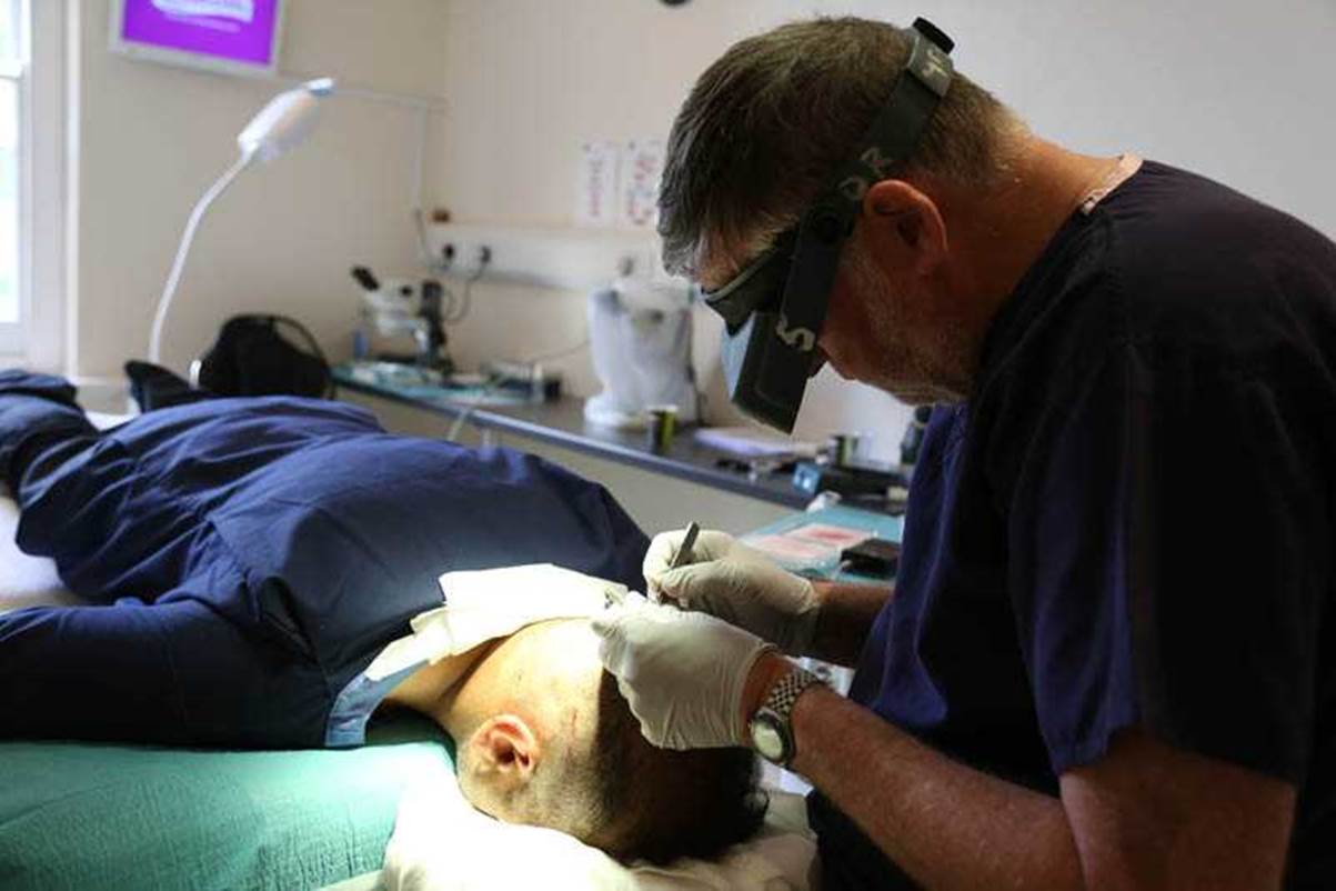 Dr. Michael May performing a hair transplant