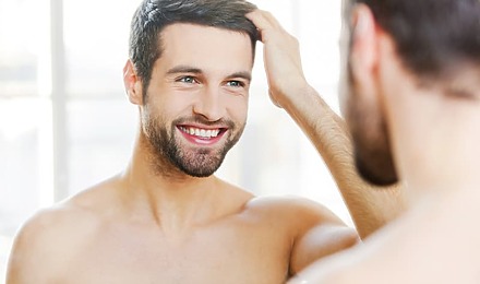 Man Admiring Successful Hair Transplant