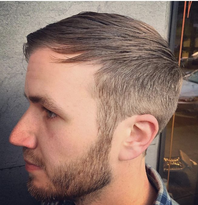 man styling his hair to disguise receding hairline