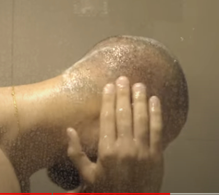 person washing their scalp 10 days post transplant