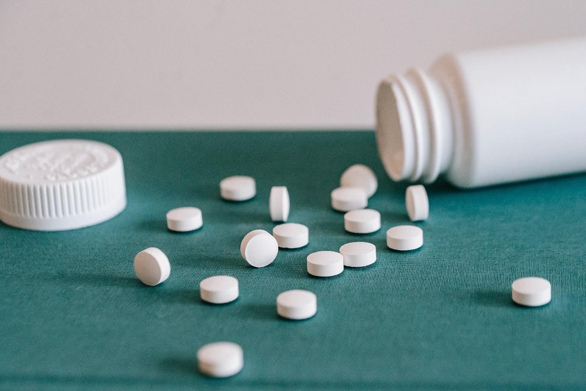 tablets and an open bottle of tablets