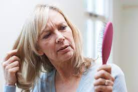 woman brushing her hair worried