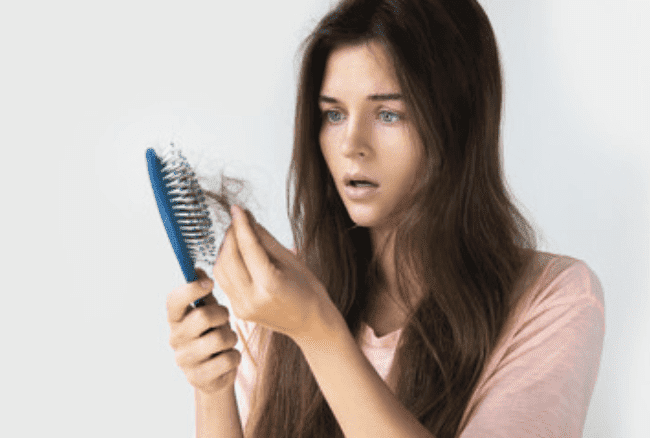 woman finding hair in brush